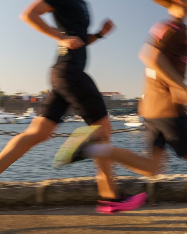 Two people running for cardio workout in proper fitness clothes