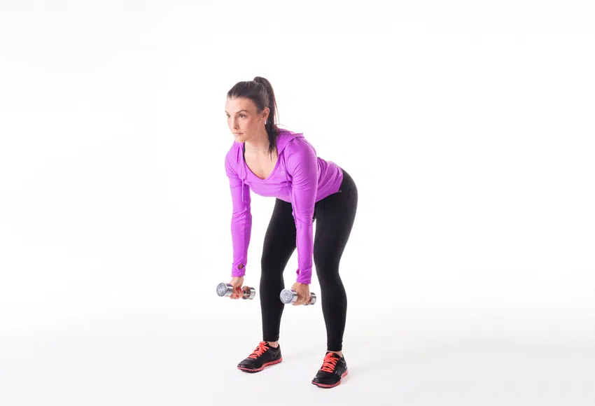 Person performing dumbbell deadlifts, standing with feet hip-width apart and holding a dumbbell in each hand, hinging at the hips and lowering the dumbbells towards the floor to strengthen the posterior chain.
