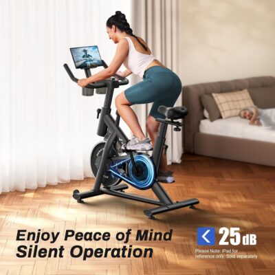 Woman riding smart exercise bike in living room.