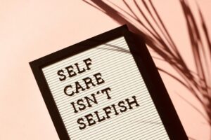 A board displaying the text 'Selfcare isn't selfish' as a reminder of the importance of personal wellbeing.