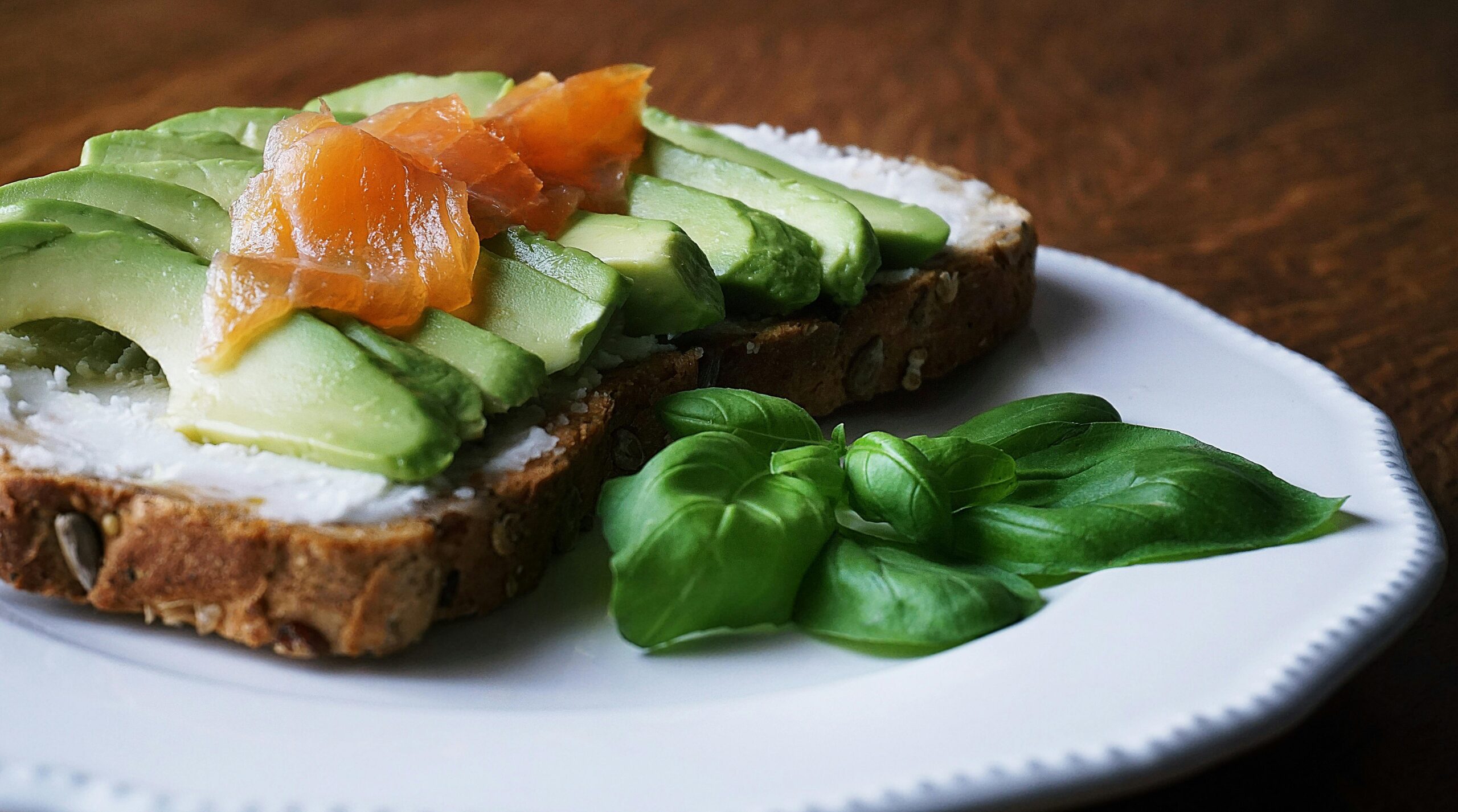 Open sandwich with avocado and salmon on a plate