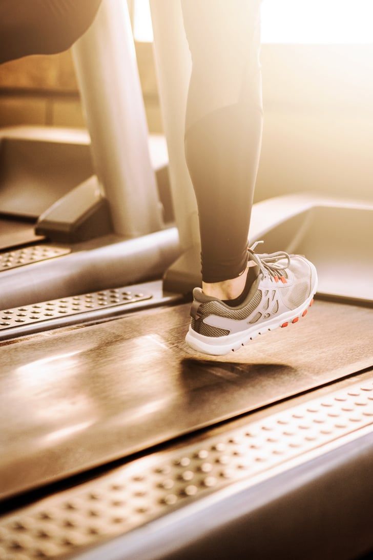 Cardio exercise close up of woman running on treadmill