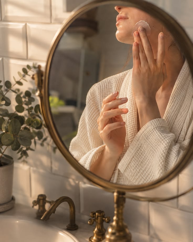 Woman doing her skincare as part of taking care of her wellbeing.