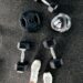 Dumbbells and weights laid out on the ground.