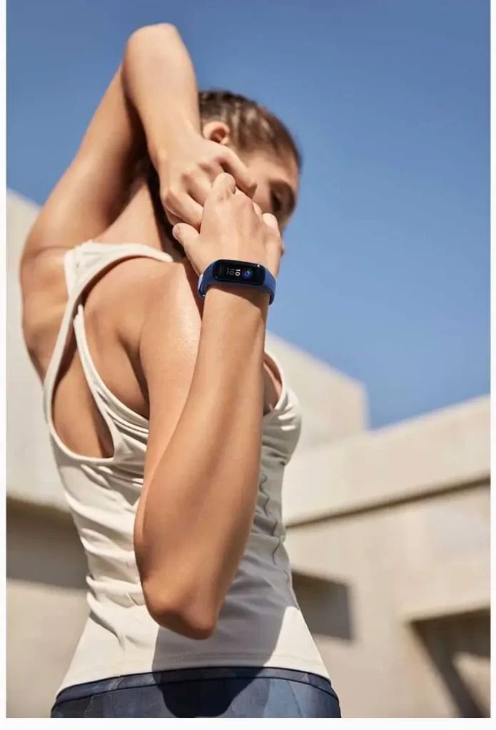 Woman stretching with stopwatch on wrist.