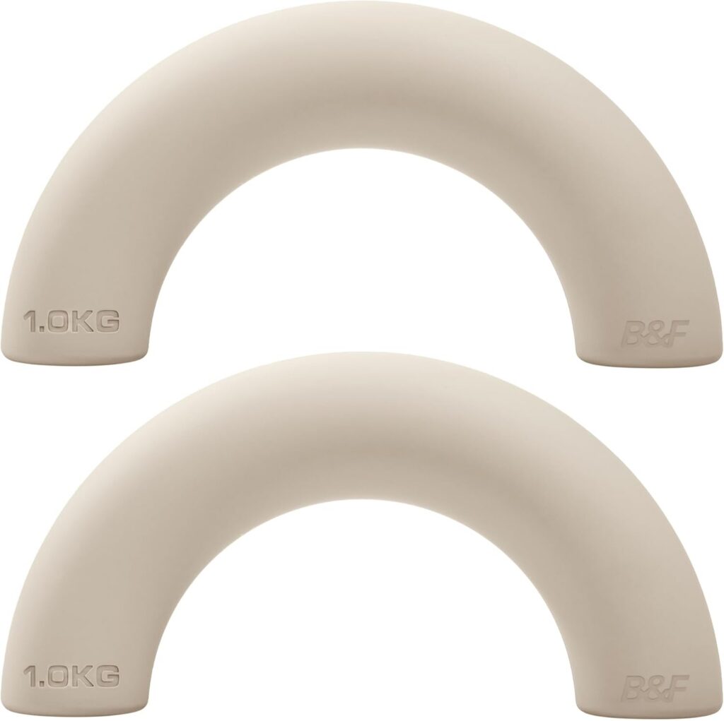 Set of cream coloured arched decorative dumbbells gym equipment