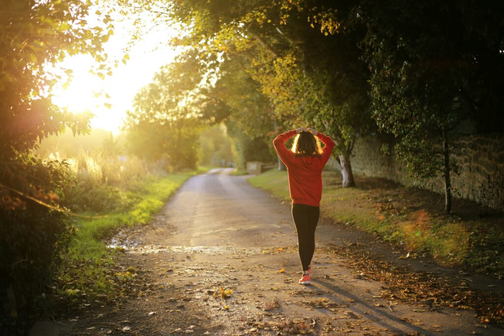 Girl brisk walking in nature for cardio