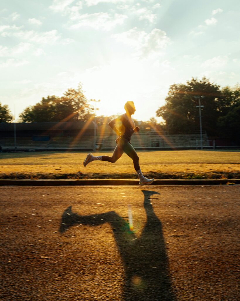 Man running through the sun rays for cardio 