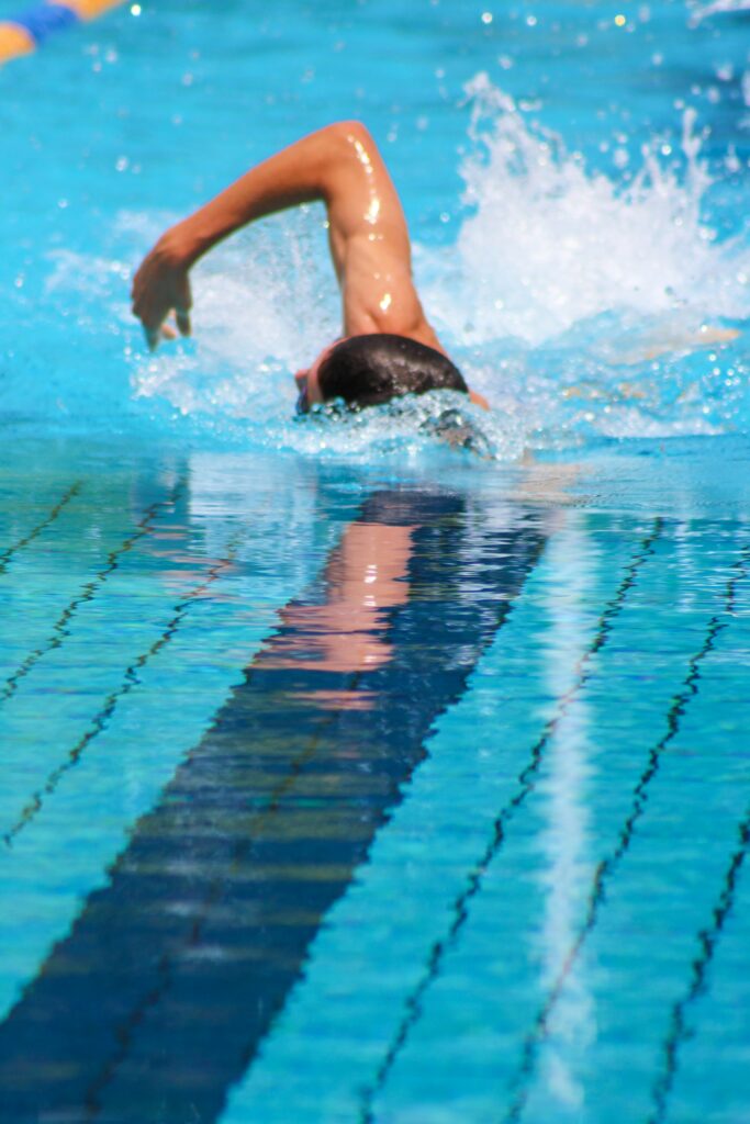 Man swimming in a lap pool for cardio