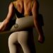 woman holding yoga mat which can be used for pilates
