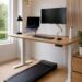Walking pad under a standing desk in a modern home office, ideal for walking while working.