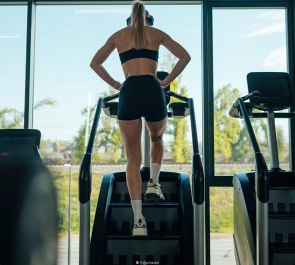 Girl using StairMaster in Gym