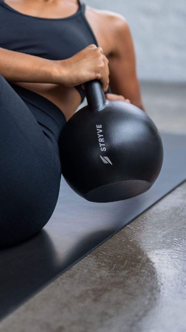 Close cropped image of woman using a kettlebell for a workout