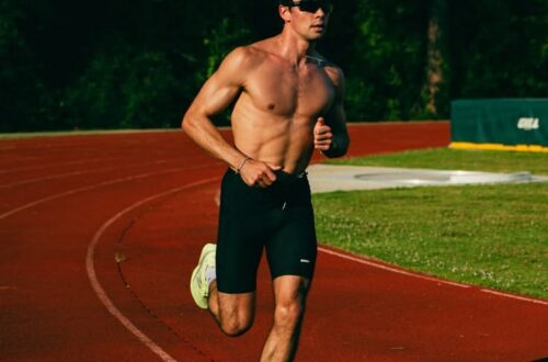 Man sprinting on racetrack.