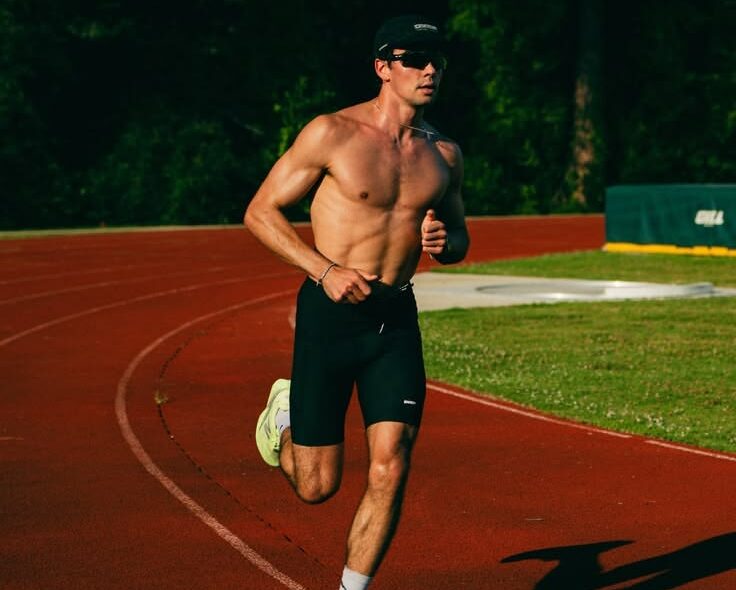 Man sprinting on racetrack.