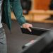 male running on contemporary treadmill on blurred background of sport club