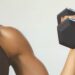 Close up of woman's arm with dumbbell.
