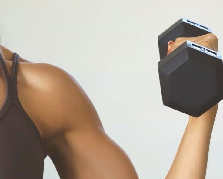 Close up of woman's arm with dumbbell.