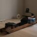 neutral Merach rowing machine in a dim lit room on its own that's featured in our best rowing machine for home guide
