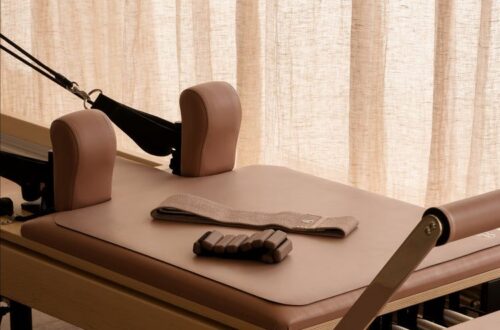 Closeup of Pilates Reformer machine with accessories on top
