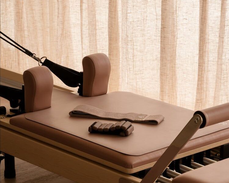 Closeup of Pilates Reformer machine with accessories on top